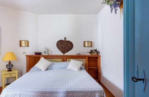 Cala Liberotto Apartment | Cozy apartment, 150 from the beach. Family-friendly, with garden and parking.