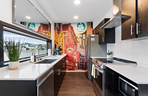 The Gulch Condo | Urban Condominium: Featuring a Pool and Balcony in a Contemporary Mid-Rise