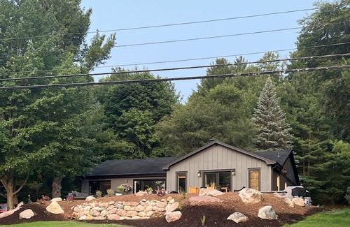 Rapid City House | 50 feet of Torch Lake frontage! Boathouse, beautiful patios sweet little beach.