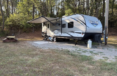 Jacob RV Rental | Camper in country setting beside water, near Burning Star Wildlife area