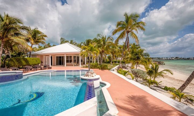 Marsh Harbour House | Emerald Moon Cottage - Beachfront rental with infinity pool, 35' private deep water dockage, 6' LWD & back up generator. Located in the exclusive gated community of Sunrise Bay